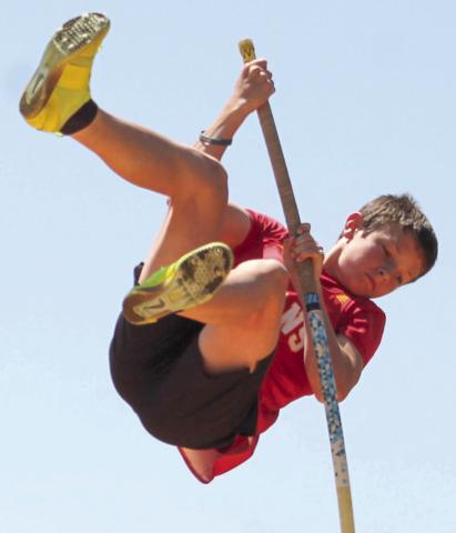 Tanner Scott (left) clears the bar for a new school record in the eighth grade boys pole vault with a height of 9’7” at the Columbus Invitational Meet, Monday. The previous record was set in 2022 by Jayden Rodriguez with a height of 9’6”.