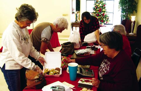 When the St. Bridgett’s Cookie Walk opened in Scammon Saturday morning the lines had formed outside the Parish Hall and it never slowed down until the cookies were exhausted. Making a purchase were Joyce Forrest and JoAn Sullivan.