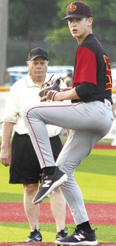 Umpire, Jay Wary, keeps a close eye on Titan Freshman Pitcher, Jonas Stover, as he tossed two strike outs and issued one walk with no hits and no runs to close out the final two innings of the win over the Trojans in Girard, Thursday.