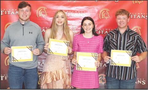 Four Columbus Seniors were awarded the Columbus Community Foundation Maureen Paulsen Scholarship during the Senior Assembly, May 16 in the Columbus Unified High School Gymnasium. Brandon Stice, Anna Head, Mallory Thompson, and Kanyen Smith each received a $1,000 scholarship, presented by Kelly Walters, USD 493 Title 1 Reading Specialist.