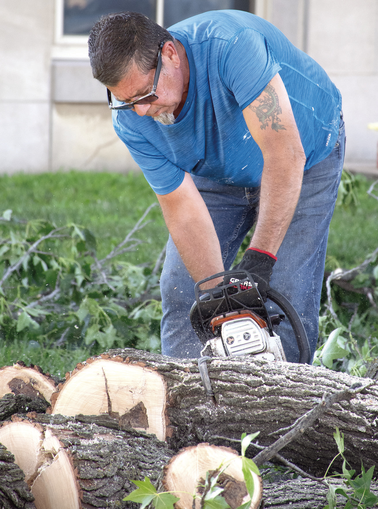County Facilities Maintenance Director Mike Thomas was busy Monday morning removing debris from the courthouse lawn. The large branch from a sweetgum tree fell during storms that ripped through the county Saturday evening.