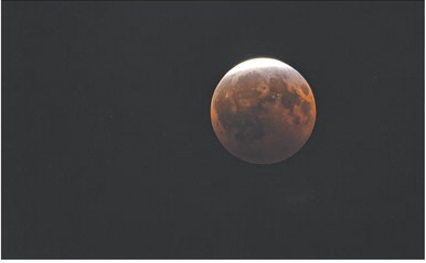 A near total lunar eclipse was visible to Cherokee County residents Thursday, August 27. This photo was taken near the eclipse’ peak at 11:12 p.m. Central Time from the sidewalk along 105 South Pennsylvania Avenue. For nearly three and a half hours the earth cast its shadow across the lunar surface.