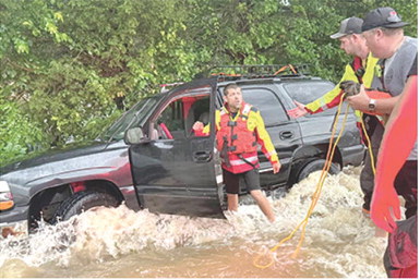 Emergency personnel were busy late Sunday night and early Monday morning performing water rescues of people who had driven into high water. Cody Burton, Dylan Koehler and Korey Lucian were among the firefighters from Columbus. Photo courtesy Columbus Fire Department.