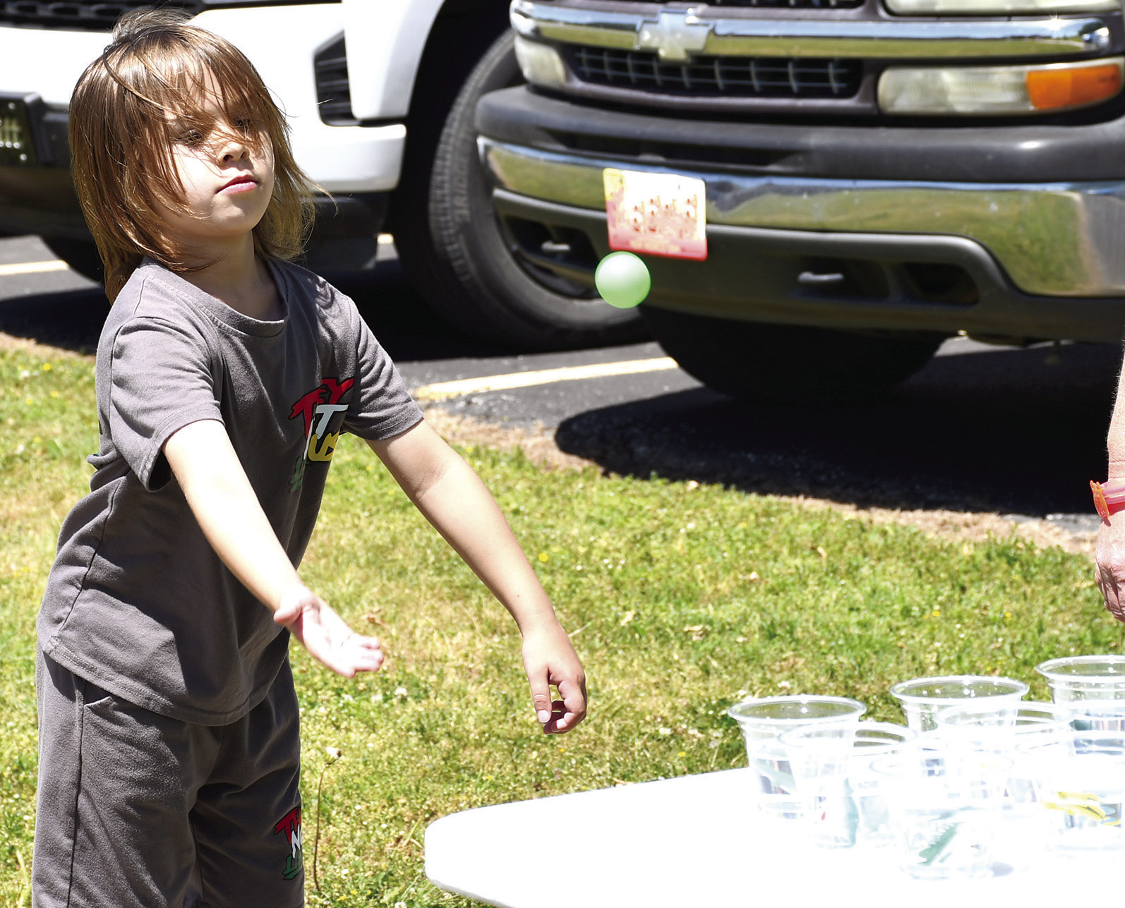 Aiming for one of the small cups, Malco Wilkins tossed his ping pong ball in an effort to win a prize at the Park School carnival held before school let out for the summer.
