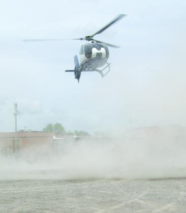 The dust became thick almost hiding the Medflight helicopter as it landed on the parking lot surface.