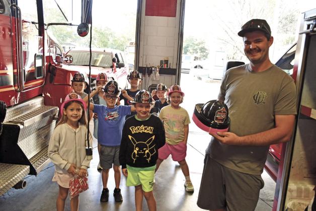 Youngsters in Rylee Crain’s Central second grade class toured the Columbus Fire Department during Fire Prevention Week. Fire Fighter Hunter Burton, passed out fire hats for the youngsters to take home.