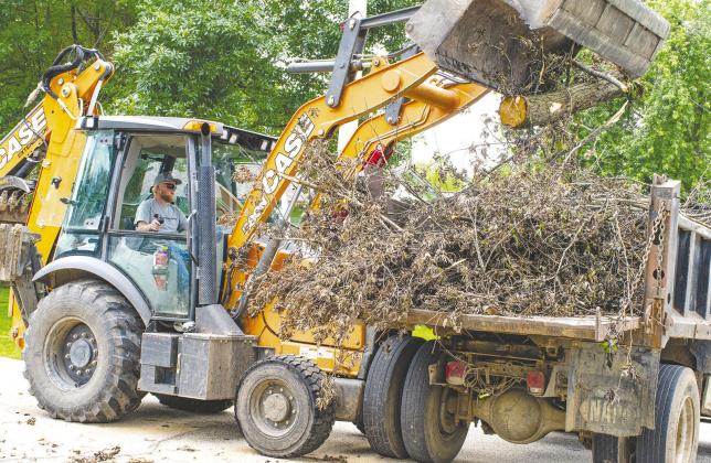With recent storms, many Columbus residents have seen limb and tree damage accumulate. City equipment operator Levi Thompson places brush in one of several waiting dump trucks as city crews work to pick up debris set out for collection by area residents. The city anticipates running the pickup through the end of the month before crews begin work on road milling in preparation for summer street projects.
