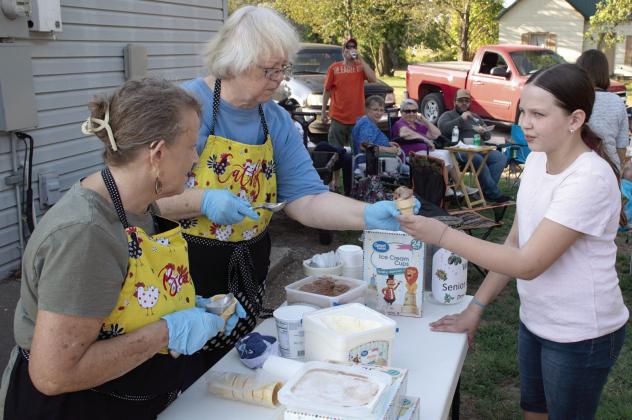 Lines formed for ice cream cones during the Annual Weir Homecoming BeanFeed September 18. Members of the Weir Senior Center offer free ice creamcones to those in attendance, youngster Emma Young was first in line to get a chocolate cone.