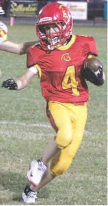 Columbus Junior High Seventh Grader, Dayton Hughes, gets a short gain around the end in the 0-0 tie with the Labette County Grizzlies, Monday, at Titan Stadium.