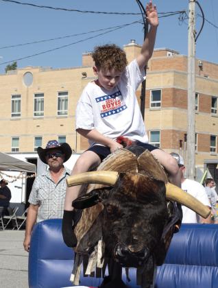 Mechanical bull riding was popular among those attending the Columbus Day Festival. Mason Boyes of Galena took his turn riding the mechanical bull Saturday, October 10.
