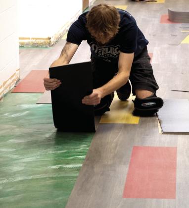 Crews were busy over the summer holiday updating the floor in the Central Elementary new gym. The modern red, gold and grey tile now grace the downstairs lobby and upstairs hallway.