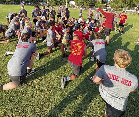 Titan Head Coach Blake Burns addresses the Titan and Mini Titan players that attended the third through sixth grade camp, August 13. Coach Burns, the Titan Coaching Staff and players will host their annual Lawn Chair Scrimmage, tomorrow, at the Central School practice field. The Mini Titans will practice beginning at 8 a.m. and the varsity and junior varsity squads will take the field at 9 a.m.