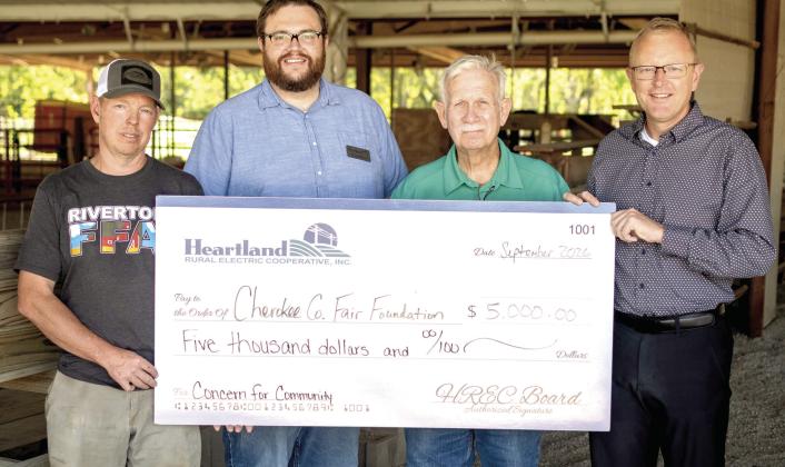Cherokee County Fair Board members Aaron Asher, Terry North and Brad Wells accepted a check for $5,000 from Heartland REC representative Doug Graham, to improve accessibility at the fairgrounds in Columbus. Courtesy photo.
