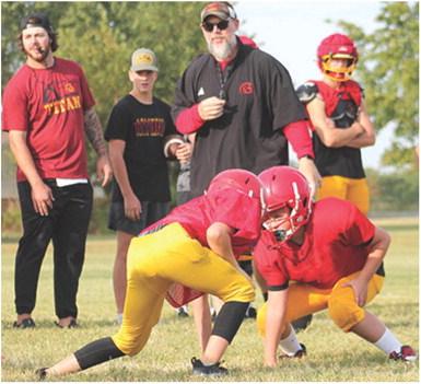 Titan Head Coach Blake Burns, assistant coach Brett Hamilton and Titan players oversee drills ran by the Mini Titans during the annual Lawn Chair Scrimmage, Saturday at the Central School Soccer Field.