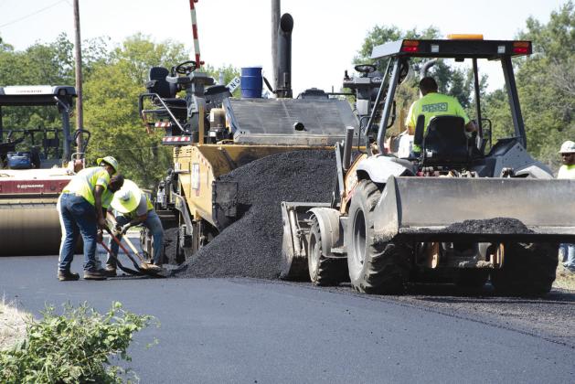 With asphalting season coming to a close, crews with APEC, a contractor hired by the City of Columbus to complete the 2026 street overlays, worked in the 400 block of East Sycamore, just east of the railroad crossing, laying a fresh pad of asphalt.