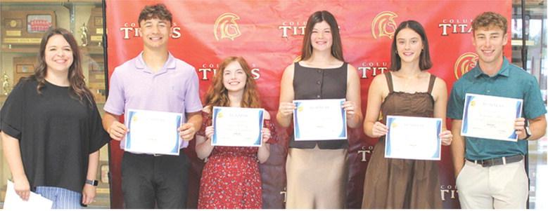 Titan Seniors Jayden Rodriguez, Ava Hulvey, Katelyn Draeger, Piper Hayes, and Lemmie Stone each received a $300 CJSHS Business Scholarship from Instructor Laura Boeckman during the Columbus Unified High School Senior Awards Assembly, May 15, in the high school gymnasium.