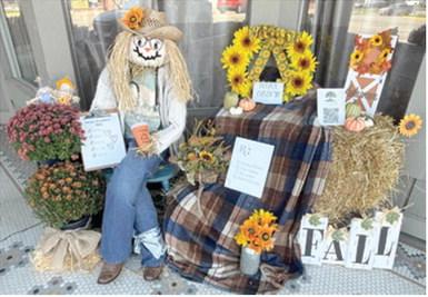 Winners of the annual Columbus Day Scarecrow contest have been announced. First place was awarded to Acorns to Oaks. They created this festive fall scene in front of The Maple District. Courtesy photo.