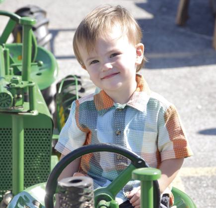 Ivan Romanov of Columbus sits atop an antique tractor during the downtown Columbus Day festival on October 10. More than 50 antique tractors and machines lined East Pine Street between the downtown square and the Columbus Museum.
