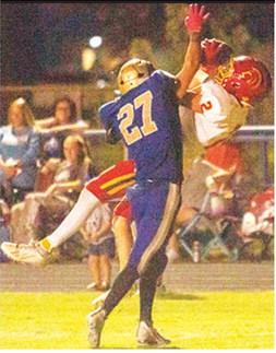 Titan Senior, Carter Woodcock, went up high and came down with the catch in the end zone, early in the fourth quarter, increasing the Titan lead over the Rams, 39-21 in Riverton. Senior, Riley Greer, attempts to defend for the home team. Photo by Kristin Sharp