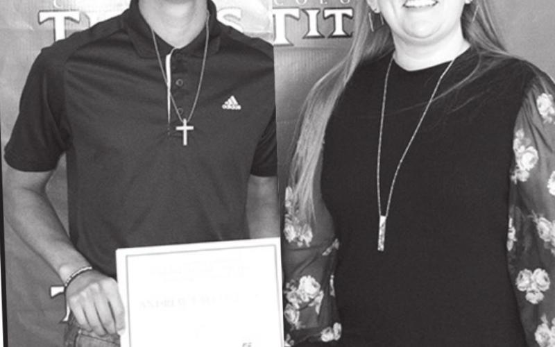 Holly Johnson presented the $500 Paul Schmidt Memorial/Cherokee County Farm Bureau Scholarship to Andrew Coberley