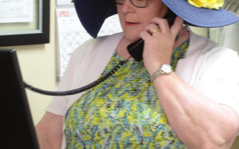 Linda Evans talks with a customer