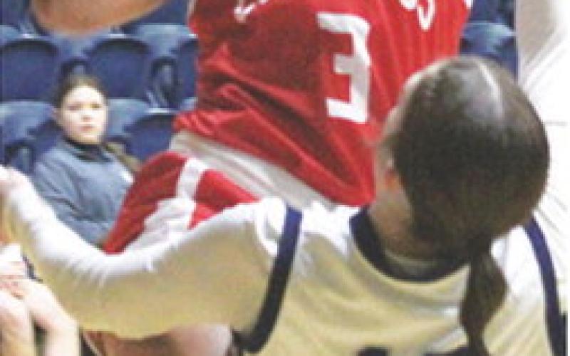 Lady Titan Senior, Brylie Johnson, goes up for two and gets an old-fashioned three on a foul by junior, Morgan Strong. Brylie finished with 15 points for Columbus in their, 43-37, win at Galena, Tuesday.