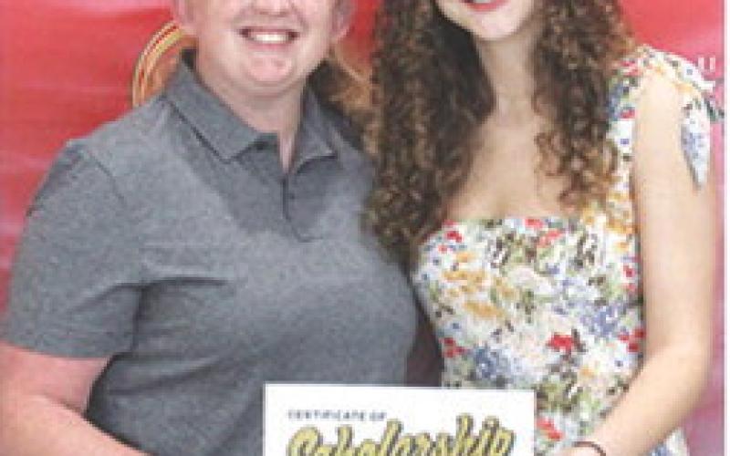 Ruby Stover earned a music scholarship and Presidential Scholarship from Emporia State University in the amount of $26,250 from CUHS Assistant Instrumental Music Director, Christine Lovell, during the May 16 Senior Assembly at the Columbus Unified High School Gymnasium.