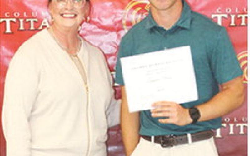 CUHS Senior, Lemmie Stone, received the Columbus Alumni Scholarship for $600 from Rebecca Spooner during the May 15 Senior Assembly at the Columbus Unified High School Gymnasium.