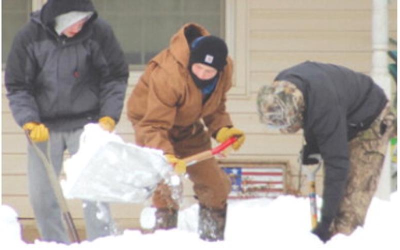 Three Titan Wrestlers Korbyn Newberry, Chase Pelt and Shade Schuberger, helped clear a path for the senior tenants to get to their mail and to the laundry area at Central Apartments Wednesday.