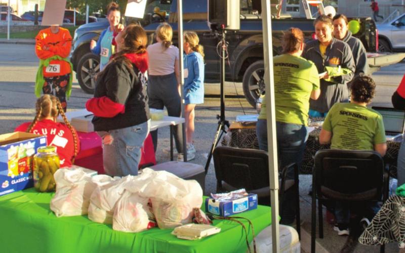 Getting ready for a spooky evening, members of the Columbus USD493 band signed up participants for the first Zombie 5K in Columbus. Along with race winners, prizes were awarded for best costume. Photo by Jacob Spencer.