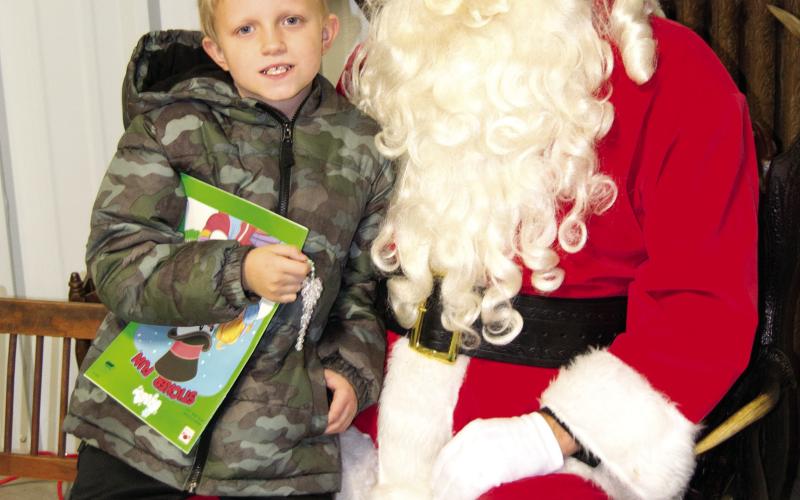 During the Columbus Museum open house Santa arrived to visit with the kiddies. Braden Pease talked to Santa about the upcoming holiday and explained how he was a good boy all year.