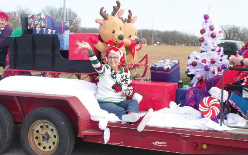 The Ozark Klassie Lassies are pulled down SE 70th Street in Riverton as part of the city’s Christmas parade earlier this month. Members dressed in festive holiday sweaters and hats all sit on a float with presents, reindeer and a Christmas tree. Photo by Jacob Spencer.