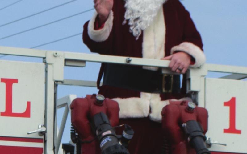Santa Claus rides atop one of Galena Fire Department’s fire engines as part of Riverton’s Christmas parade earlier this month. The magical, cherrycheeked man made several appearances in Cherokee County parades this year. Photo by Jacob Spencer.