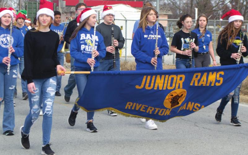The Riverton Junior Rams march at attention with a bold banner in part of the city’s Christmas parade earlier this month. Students towards the front of the line wear Santa hats to boast their Christmas pride for the excited crowds. Photo by Jacob Spencer.