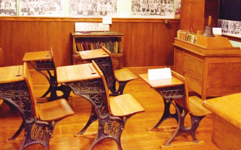 One of the exhibits inside the Baxter Springs Heritage Center is a replica of a one room school house. Class photos adorn the walls around the classroom.