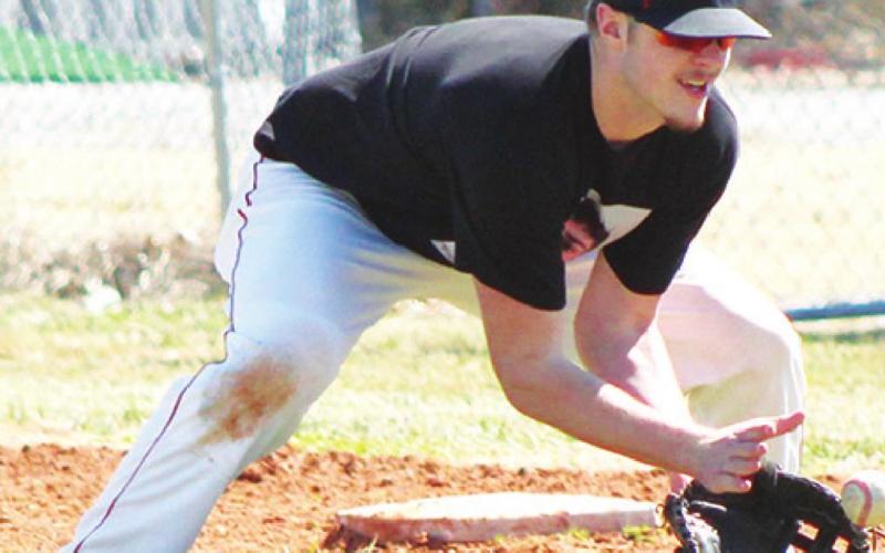 Titan Junior, Brett Hamilton, fields the ball at first base during practice, Wednesday, at the Community Field Ball Park. Brett started at first for the Titans last season and had a .281 batting average. Columbus opens tomorrow in Wyandotte, Okla.