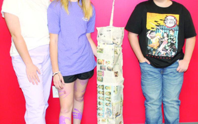 Students in Nicholas Weber’s seventh grade science class used the metric system to build scale models of the North Tower in commemoration of the 911 anniversary. The models were built using newspaper and tape with the requirement that it had to stand alone when completed. Kensley Blackledge, Brilynn Scott, Carlisle Major completed their version of the tower.