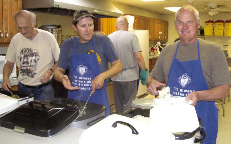 Members of the St. Rose Knights of Columbus, Ralph White, Greg Weber and Steve Kresyman, were busy dippin’ noodles and chicken for their semi-annual fund raiser Thursday. The event was called a big success.