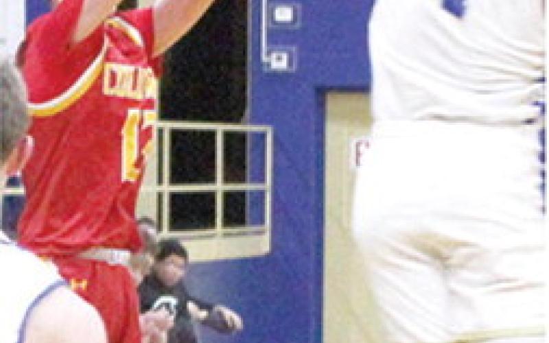 Titan Junior, Carter Woodcock had the lone threepoint basket for Columbus in their 38-73 loss in Riverton, December 19. Wookcock made this three over the outstreatched arm of junior, Aydin Witherspoon.