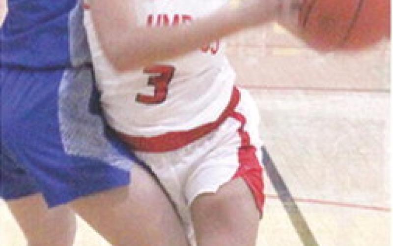 Lady Titan Senior, Brylie Johnson, looks to the basket as she moves around her Cherryvale defender on her way to a basket in the 41-60, Columbus loss to the Lady Chargers, Tuesday, at the CUHS Gym.