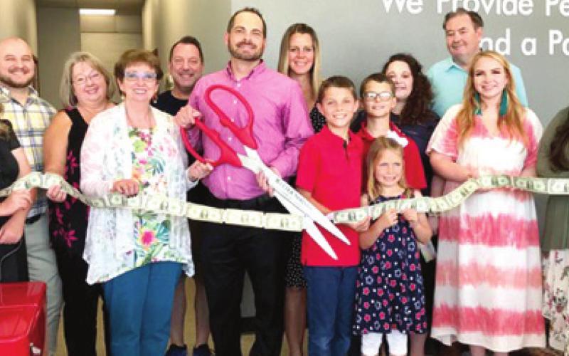A ribbon cutting and open house was held at State Farm Insurance in Baxter Springs. Those attending the ceremony included Susan Archer, Brett Hill, Tamara Ho, Chamber President Debbie Hopkins, Doug Scott, Grant Deardorff and his family Jennifer Deardorff, Drake Deardorff, Gavin Deardorff and Kinley Deardorff, Lauren Botts, Mayor Tim Shallenburger, Courtney Jenkins and Kalee Smith. Photo by Dee Riley.