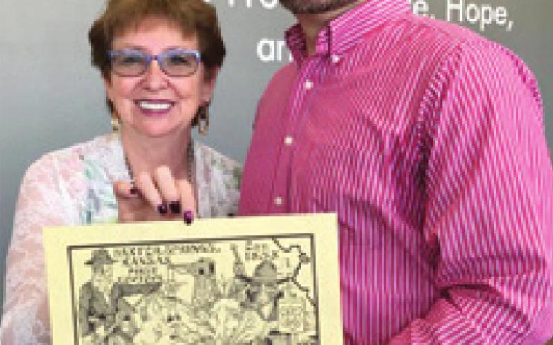 Baxter Springs Chamber of Commerce President Debbie Hopkins presented Grant Deardorff with a limited edition print at the State Farm ribbon cutting. Photo by Dee Riley.