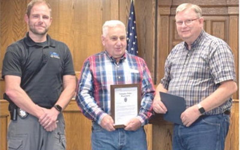 Jim Oberbeck (center) was recognized for his years of service to the City of Columbus, as well as County law enforcement. Oberbeck is retiring from his official duties. Columbus Police Chief Kyle Clark and Mayor Grant Spieth presented Oberbeck with a plaque at a recent City Council meeting.