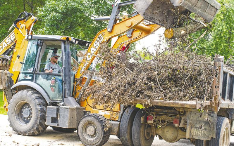 With recent storms, many Columbus residents have seen limb and tree damage accumulate. City equipment operator Levi Thompson places brush in one of several waiting dump trucks as city crews work to pick up debris set out for collection by area residents. The city anticipates running the pickup through the end of the month before crews begin work on road milling in preparation for summer street projects.