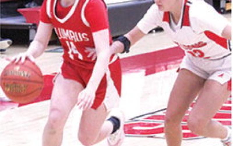 Lady Titan Junior, Bentley Townsend, drives past junior, Layla Weaver, on her way to the basket in Friday’s homecoming win over Baxter Springs, 4126. Bentley led the Columbus with 11 points.