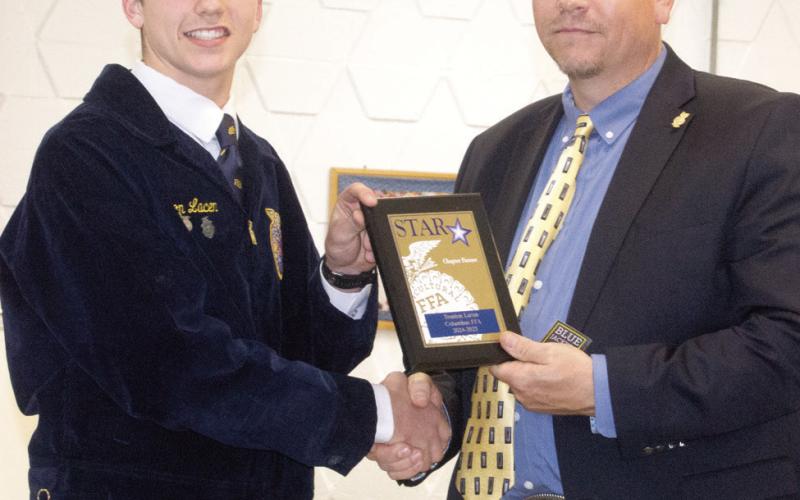 Trenton Lacen received the Star Chapter Farmer award presented for his SAE (supervised agriculture experiences) where he works for Chris Edmondson operating equipment for their row crop business.