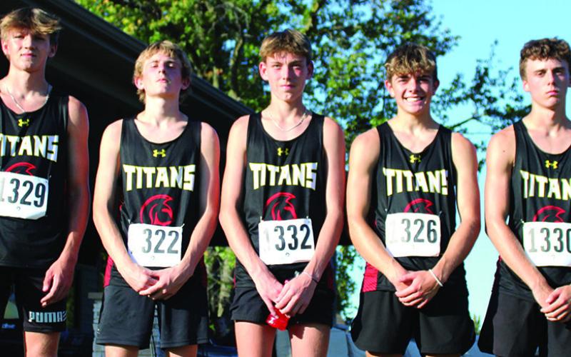 The Columbus Unified High School Boys Cross Country Team took third place in the Columbus Invitational Meet, Tuesday at the Brush Creek Golf Course. Columbus Head Coach Amanda Strickland is shown with her team as they are introduced for the medal stand. Dane Merrick, Kolton Delmont, Carter Woodcock, Easton Long, Levi Simpson, and Drake Laurance. Courtesy photo.