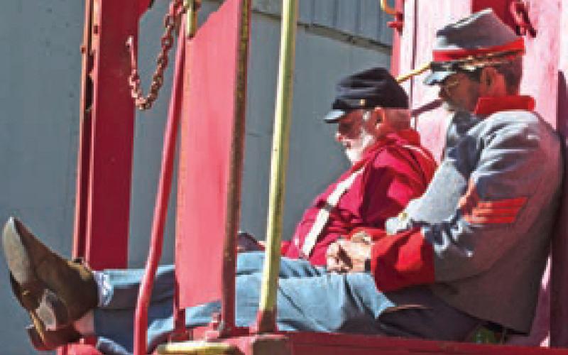 Nothing like stopping on the back of a railroad caboose for a short rest, no matter which army you are portraying. The Union and Confederate soldier re-enactors appear to be as tired as a real soldier might have been.