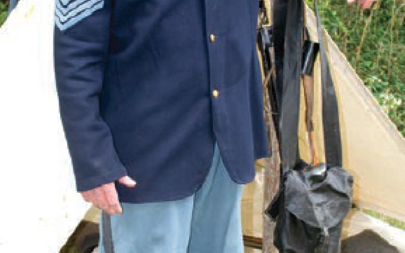 Sgt. Jason Brassfield stands beside his tent. The reenactor was portraying a soldier in the first Arkansas division of the U.S. Army. The small camp of soldiers directly behind the Baxter Spring Museum kept a campfire going through the entire encampment.