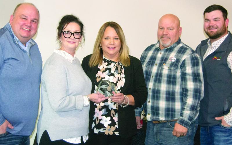 The Business of the Year award was presented to the Farmers Coop by Rebecca Spooner recognizing their involvement in community events while growing the membership and the number of locations.